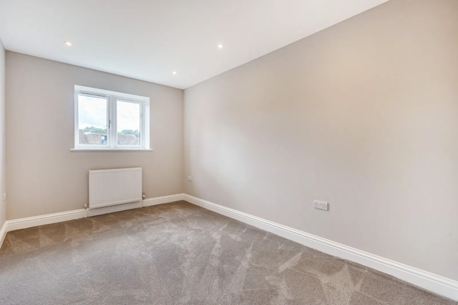 an empty room with a radiator and a window