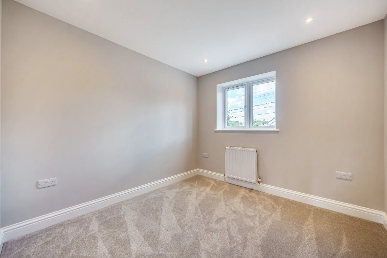 an empty room with a radiator and a window
