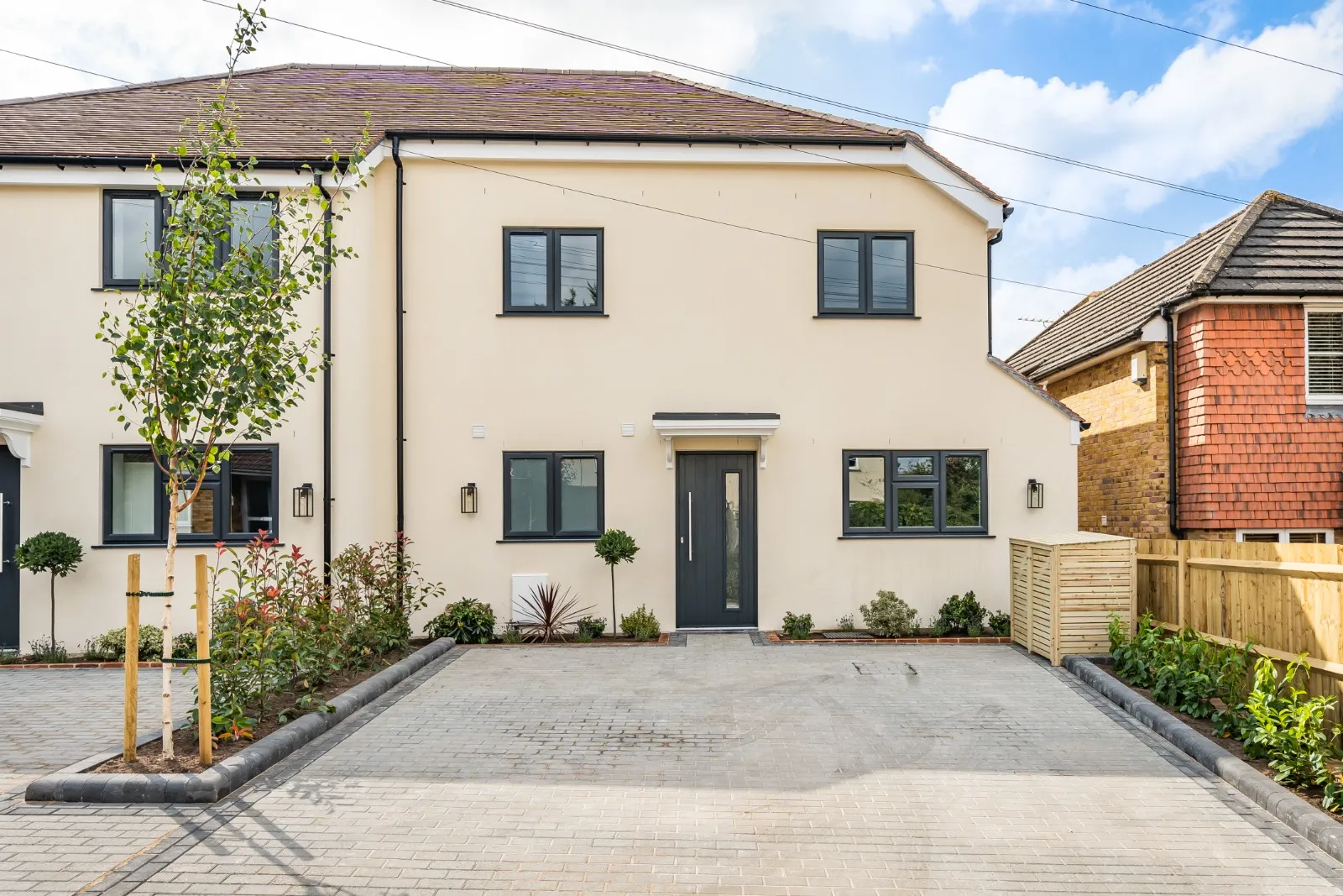 a two story house with a driveway in front of it