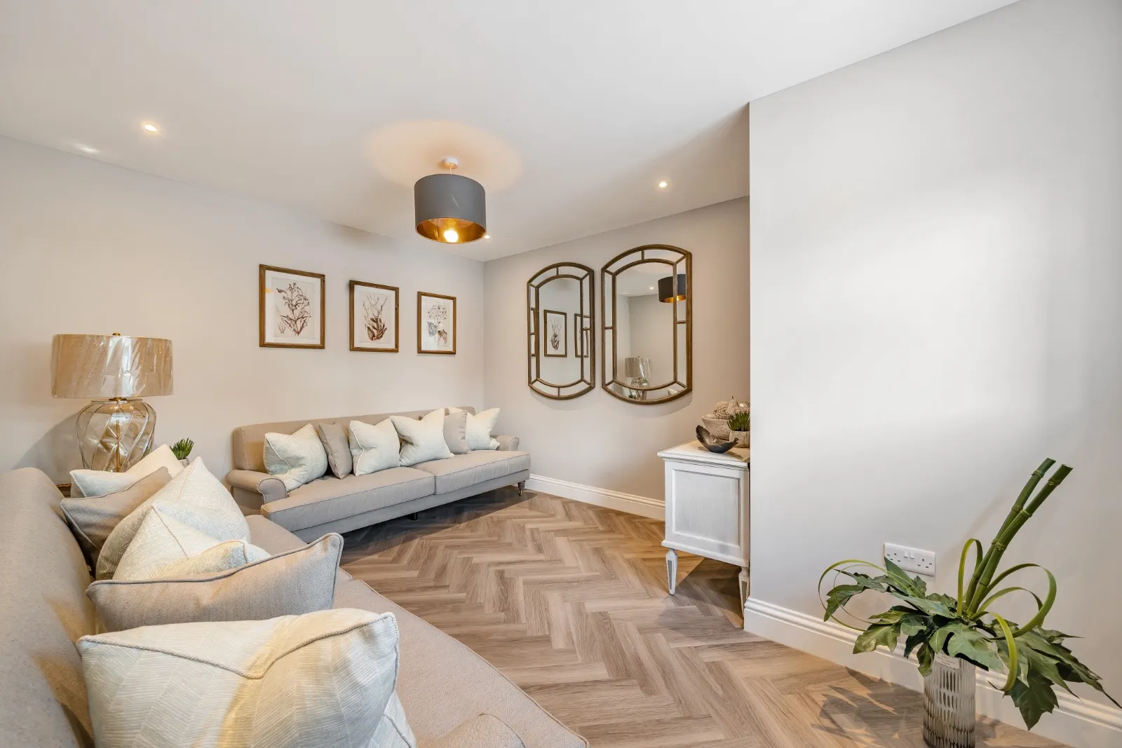 a living room filled with furniture and a potted plant