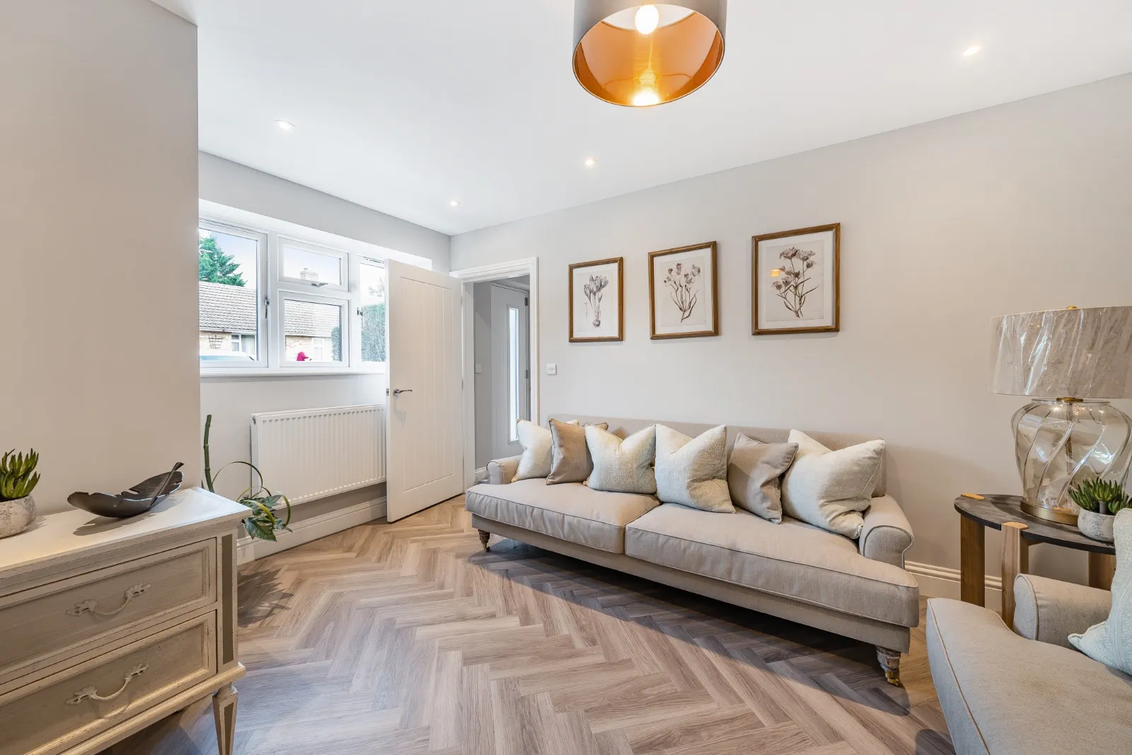 a living room filled with furniture and a wooden floor