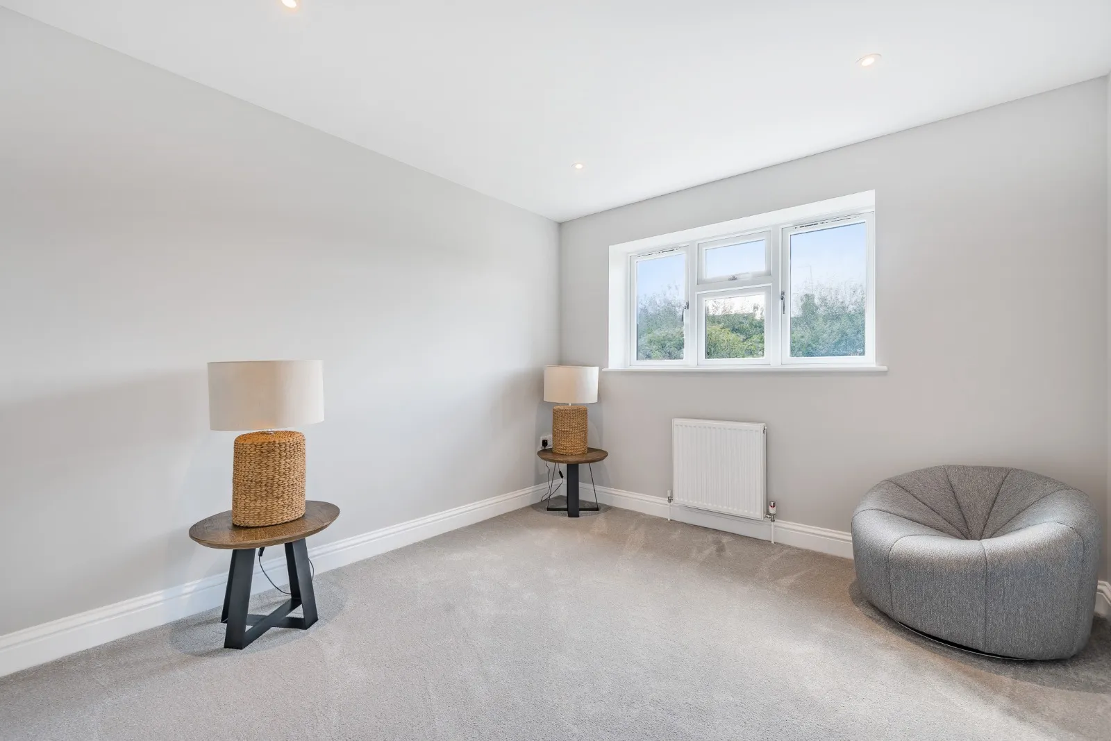 a living room with a chair and a lamp